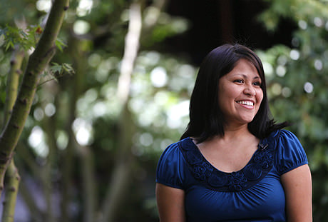 A female teacher smiling.