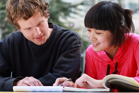 A male and female college students studying.