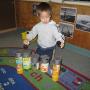 child building with cans